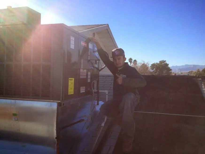 HVAC technician performing HVAC Inspection on a rooftop unit in Westchester